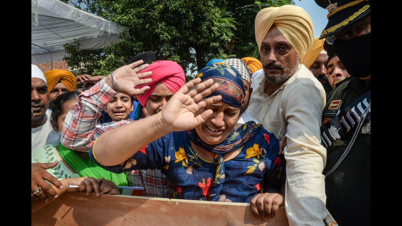 Martyr Naib Subedar Jaswinder Singh's wife Sukhpreet Kaur wails as she salutes him during his funeral, at Mana Talwandi village in Kapurthala district. Pic/PTI